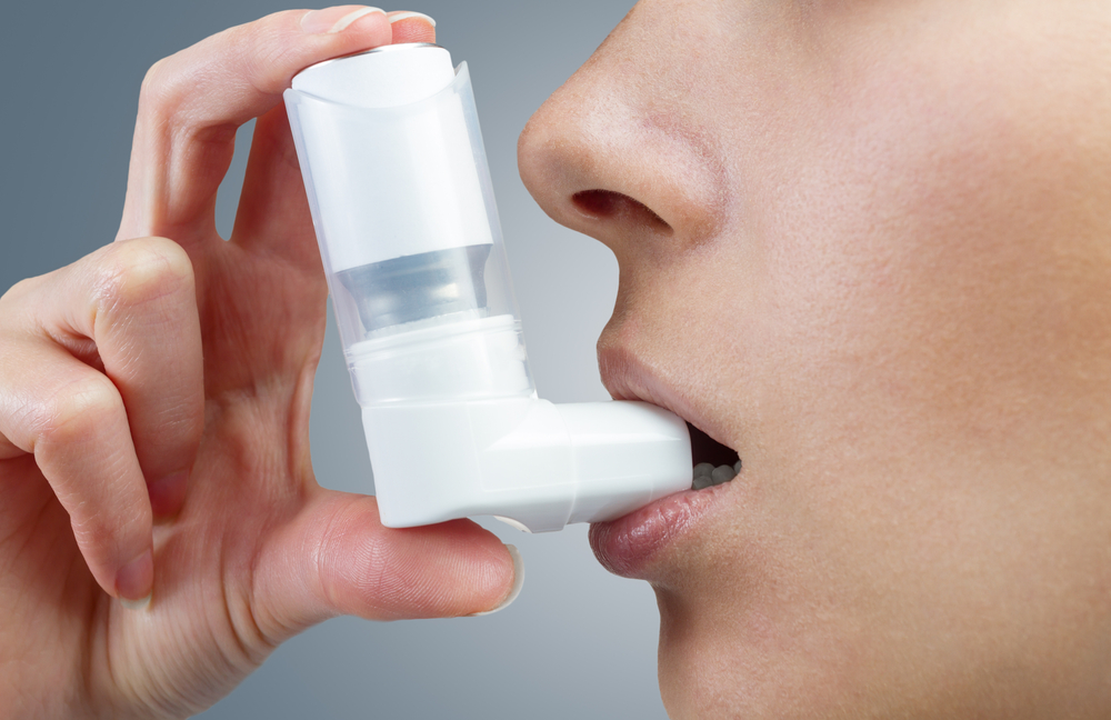 Woman,Uses,An,Inhaler,During,An,Asthma,Attack,,Close-up